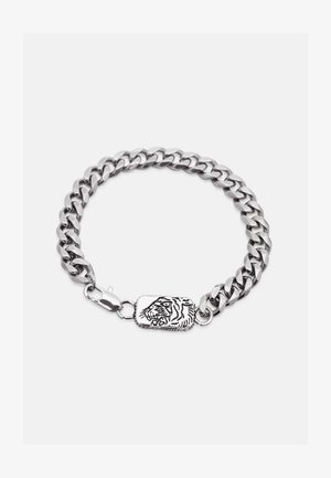 Hõbedane kettrauaga käevõru, millel on paksud lingid ja ristkülikukujuline kinnis, millel on graveeritud möirgava tiigri pea kujundus.