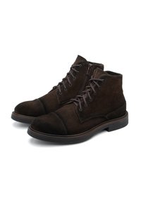 Brown suede ankle boots with a round toe, cap toe detail, and contrasting laces. Features a side zipper for easy wear. Flat rubber sole.