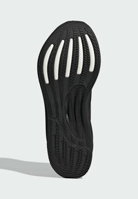Suola nera di sneaker in gomma testurizzata, con accenti bianchi e un motivo a onda. Design curvo con scanalature prominenti per una maggiore aderenza.