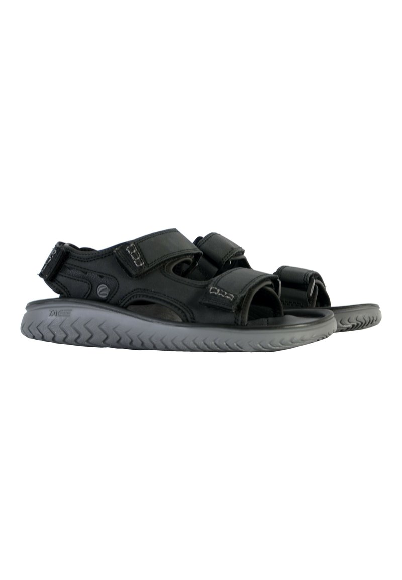 Sandales noires avec des sangles réglables, semelle en caoutchouc et semelle intérieure texturée grise. Le design ouvert à l'avant et le surpiqûre renforcée sont des détails remarquables.