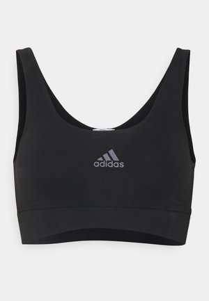 Černá sportovní podprsenka vyrobená z elastického materiálu, s kulatým výstřihem, širokými ramínky a šedým logem Adidas na přední straně. Hladká textura.