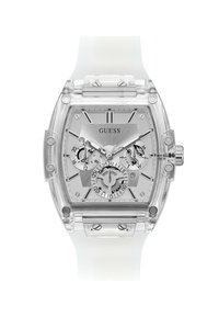 Orologio rettangolare trasparente con cinturino in silicone bianco, quadrante argento con più sottodial e accenti metallici. Nome del marchio "GUESS" visibile.