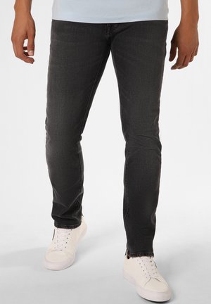 Dark wash slim-fit jeans with a smooth texture, featuring a classic five-pocket design, worn with white sneakers.