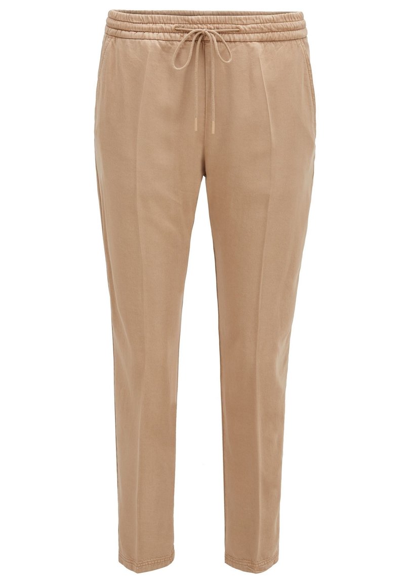 Beige jogger pants with an elastic waistband and drawstring. Lightweight fabric, tapered legs, and subtle front creases.