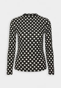 Camisola de manga longa em tecido canelado preto com grandes bolinhas brancas. Apresenta um decote redondo e silhueta ajustada.