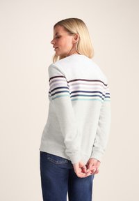 Gray sweatshirt featuring horizontal stripes in purple, teal, and blue on the back. Long sleeves and crew neck design. Cotton blend material.