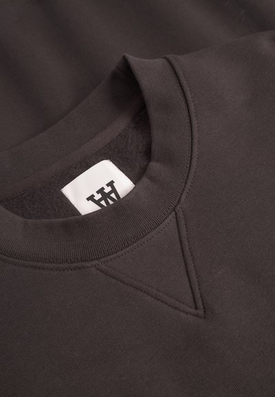 Dark gray sweatshirt featuring a round neckline, ribbed cuffs, and a V stitch on the front. Soft texture with a woven label inside.