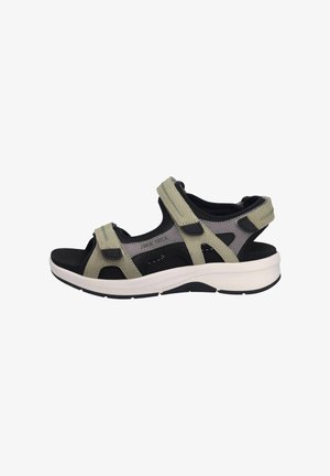 Sandalias de color verde claro y negro con correas ajustables, diseño de punta abierta, plantilla acolchada y suela de goma blanca.