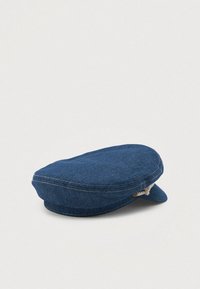 Denim cap in dark blue with rounded shape and slight visor. Features visible stitching and a textured finish. No embellishments noted.