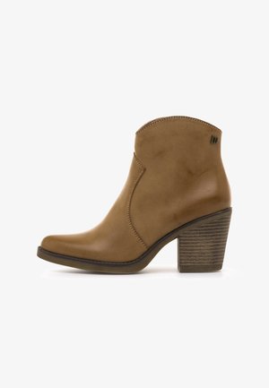 Tan leather ankle boot with stacked block heel and rounded toe, featuring decorative stitching and a small metal logo near the opening.