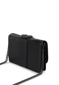 Czarna torebka crossbody z imitacji skóry, z pikowanym wzorem, srebrnym łańcuszkiem i ozdobnym zapięciem na górze. Kompaktowy, prostokątny kształt.