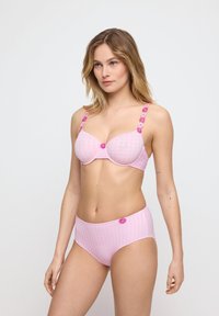 Light pink lingerie set with checkered texture. Bra features floral accents on straps; high-waisted brief with matching flower detail.