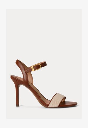 Brown leather high-heeled sandal with beige woven toe strap and adjustable gold buckle ankle strap, slim stiletto heel.