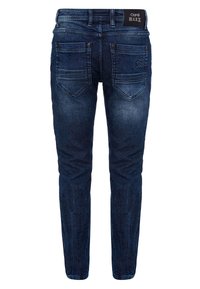 Jean en denim bleu foncé avec une coupe slim, dotés de deux poches arrière avec de subtils détails de couture et une taille avec logo.