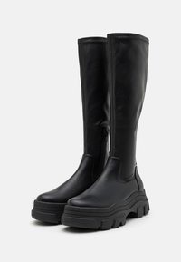 Bottes noires jusqu'aux genoux en cuir lisse, avec une semelle en caoutchouc épaisse, une fermeture éclair sur le côté et un design épuré.