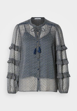 Transparante blauwe blouse met patroon, voorzien van gerimpelde mouwen, striksluiting bij de nek en knoopsluitingen. Heeft een ingewikkeld geometrisch ontwerp in lichtere tinten.