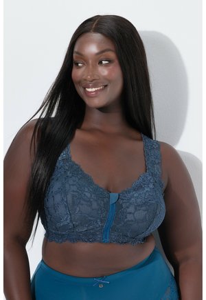 Reggiseno in pizzo azul scuro con zip frontale, design floreale e spalline larghe. Tessuto liscio con bordi in pizzo dettagliati.