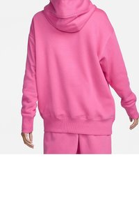 Oversized hooded sweatshirt in bright pink, featuring a soft texture, ribbed cuffs and hem, with a relaxed fit and minimal design.