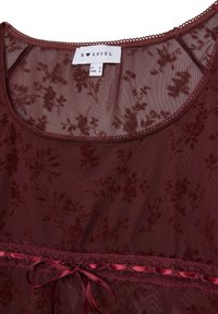Top trasparente bordeaux con motivo floreale, bordo in pizzo e nastro in satin legato in vita. Presenta un collo rotondo e una consistenza morbida.