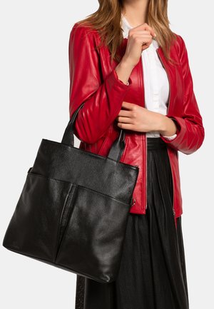 Black leather tote bag with textured finish, flat design, and double handles. Features a central seam and a clean, minimalist silhouette.
