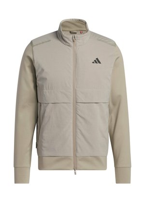 Giacca zip-up beige chiaro con colletto alto, due tasche frontali e logo Adidas nero sul petto.
