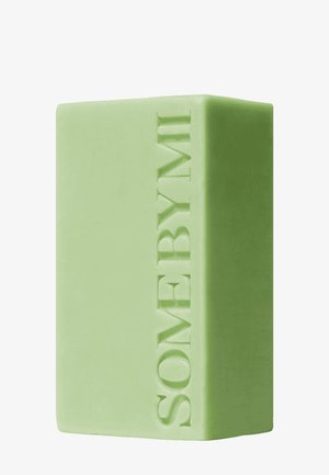 Pain de savon rectangulaire vert clair avec le mot SOMEBYMI embossé verticalement sur le côté.