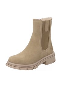 Botín beige de tobillo con material de ante, paneles laterales elásticos, suela de goma gruesa y acentos de costura en contraste. Diseño de punta redonda.
