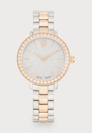 Silver and rose gold wristwatch with a glittery silver dial, crystal-studded bezel, and metal bracelet featuring alternating links.