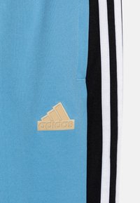 adidas Performance TIRO NATIONS PACK UNISEX - Treningo apatinė dalis - light blue/black/white
