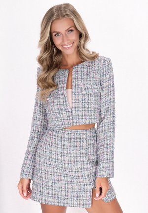 Two-piece outfit featuring a cropped jacket and mini skirt in a multicolored, textured tweed pattern. Colors include blue, white, and pink.