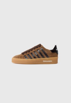 Brown suede sneaker with black patent leather stripes, lace-up front, and a rubber sole. Features a branded back heel detail.