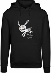 Black hoodie featuring a white sketch of a rabbit with red eyes and the text "WALK IN THE DARK" in white. Soft fabric, kangaroo pocket.