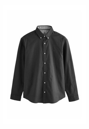 Mustad nööbiga särgid, millel on kraenupp, pikad varrukad ja valged nööbid. Sisekrae peal on ruuduline muster. Pehme kangast tekstuur.