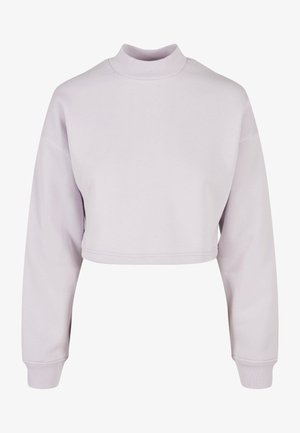 Világos levendula színű, rövid fazonú pulóver magas nyakkal, hosszú ujjakkal és bordázott mandzsettával. Simogatós pamut anyag, minimalista dizájn.