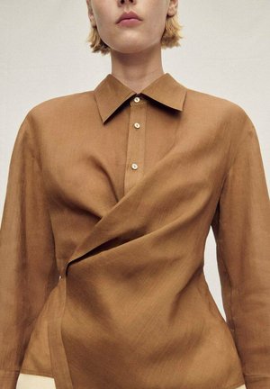 Brown, button-up shirt with a collared neckline and draped design. Features a smooth, soft texture and subtle shine.