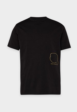 T-shirt noir à manches courtes avec un petit logo doré représentant le portrait de Karl Lagerfeld, en bas à droite sur le devant.