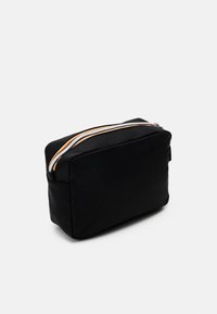 Black fabric rectangular cosmetic bag with a zippered top. Features three colored stripes on the zipper. Soft, padded texture.