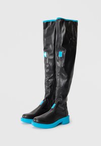 Knee-high black synthetic boots with a blue sole and accents, featuring a zipper and textured upper. Smooth finish, modern design.