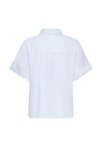 Chemise bleu clair à manches courtes avec col, couture visible au dos et coupe décontractée.