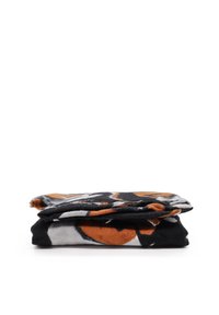 Coperta a motivi nei colori nero, bianco e arancione. Tessuto morbido con un design piegato. Presenta forme astratte e bordi sfilacciati.