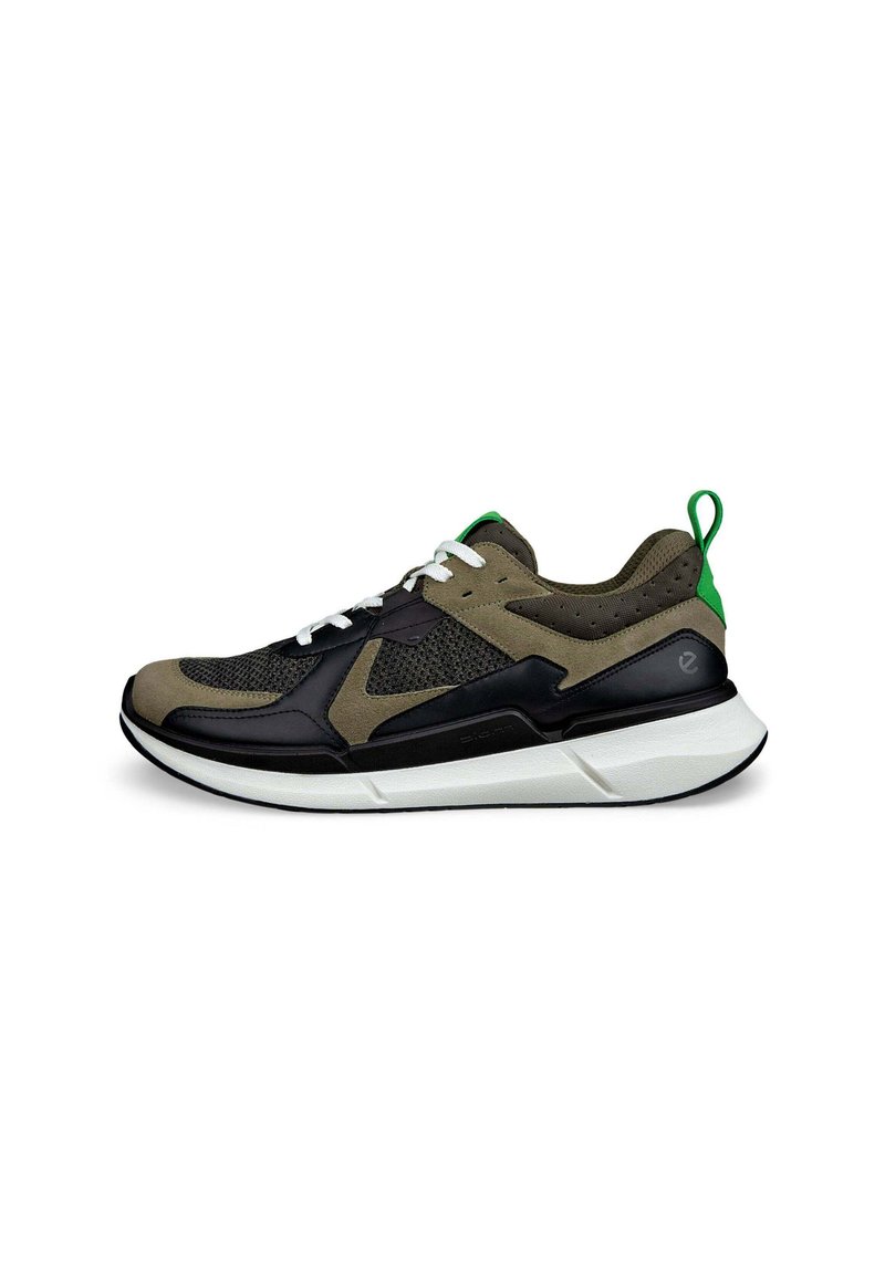Lace-up sneaker with a black and olive green mesh upper, textured accents, white midsole, and a green heel tab.