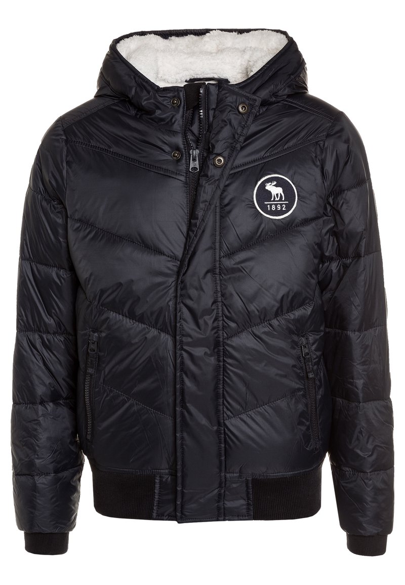 Sort dunjakke med hætte, der har en blød hvid foring, quiltet tekstur, lynlåslukning foran og et rundt logo med et elgdesign.
