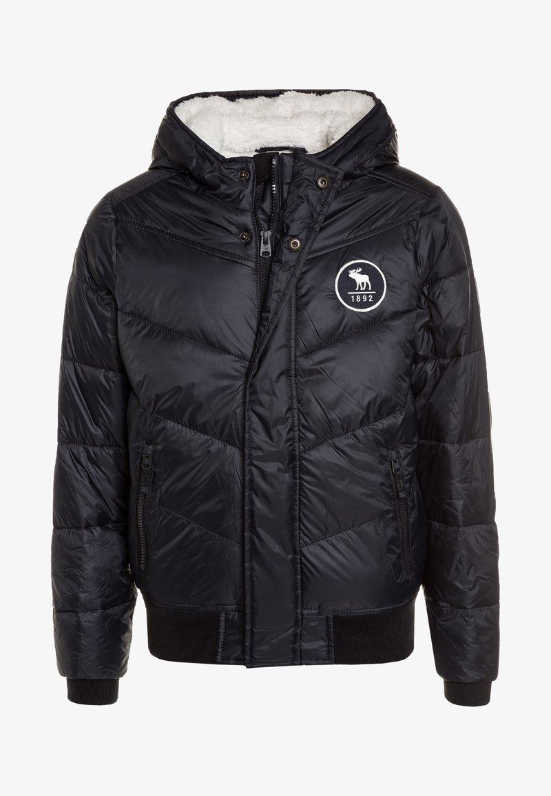 Sort dunjakke med hætte, der har en blød hvid foring, quiltet tekstur, lynlåslukning foran og et rundt logo med et elgdesign.