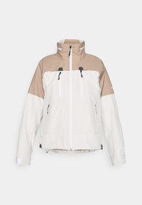Hættejakke med tofarvet design; den øverste del i tan struktureret stof og den nederste del i creme. Har frontlynlås og to brystlommer.