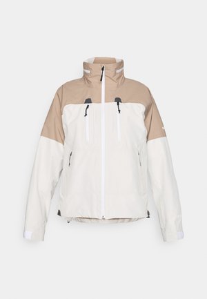 Chaqueta con capucha de diseño bicolor; sección superior en tela texturizada color marrón claro y sección inferior en crema. Presenta cremallera frontal y dos bolsillos en el pecho.