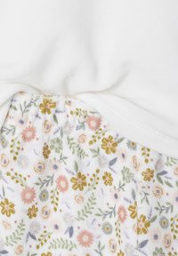 White fabric with a knot at the center, combined with a floral pattern featuring pink, yellow, and green flowers on a white background.