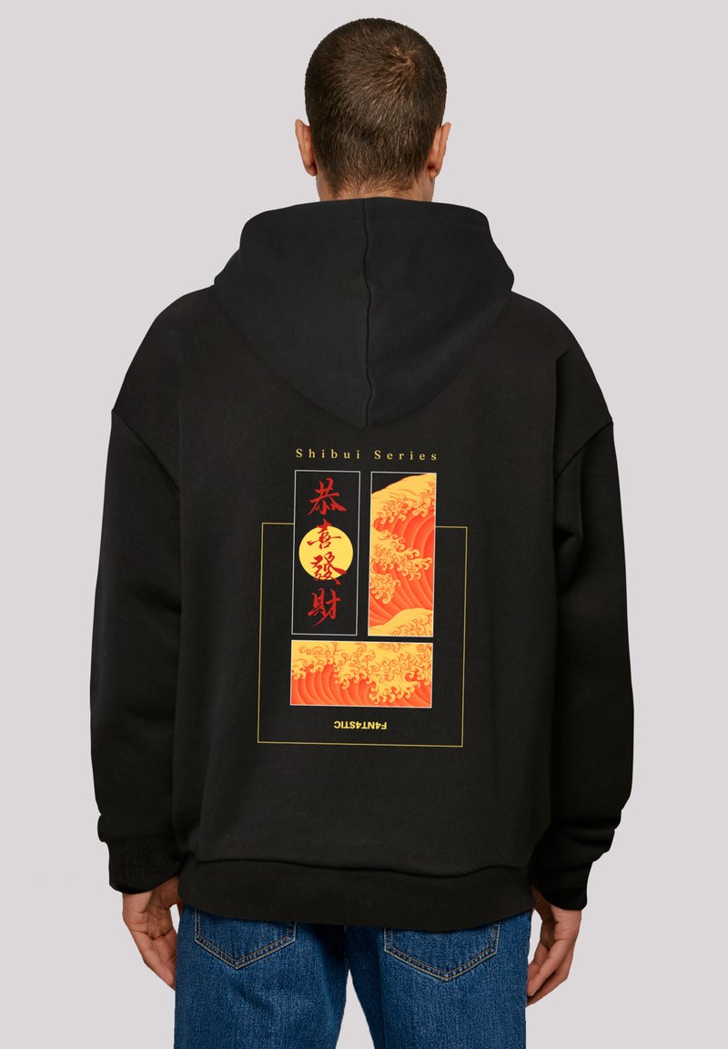 Black hoodie featuring a back graphic with red-orange wave patterns and circular accents. Casual fit, with a drawstring hood.