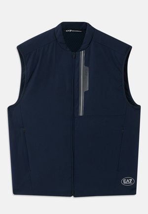 Navyblå ärmlös zip-up väst med ståkrage, vertikala reflektionsränder och EA7 Emporio Armani-logotyper på bröstet och i fållen.