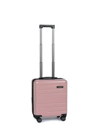 Valigia rigida compatta di colore rosa pallido, con manico estensibile nero e quattro ruote nere, in posizione verticale su uno sfondo bianco.