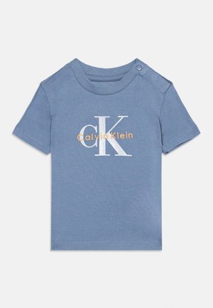 Blue short-sleeve toddler t-shirt with Calvin Klein logo in white and orange, featuring a button closure on one shoulder.